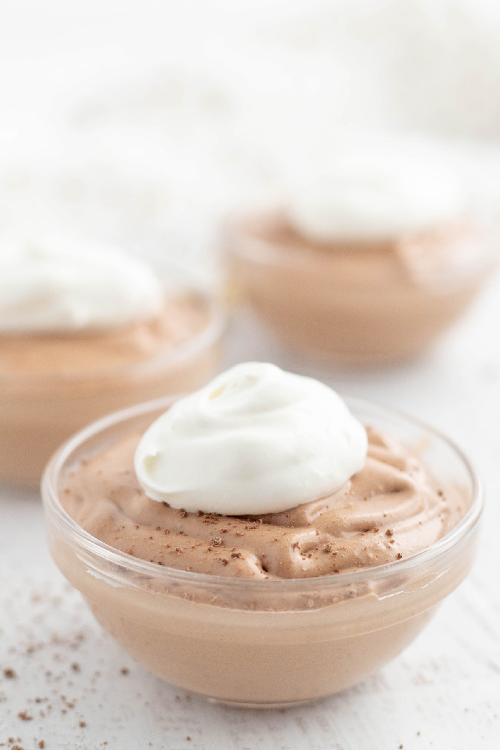 Creamy chocolate deliciousness topped with whipped topping in a dessert cup