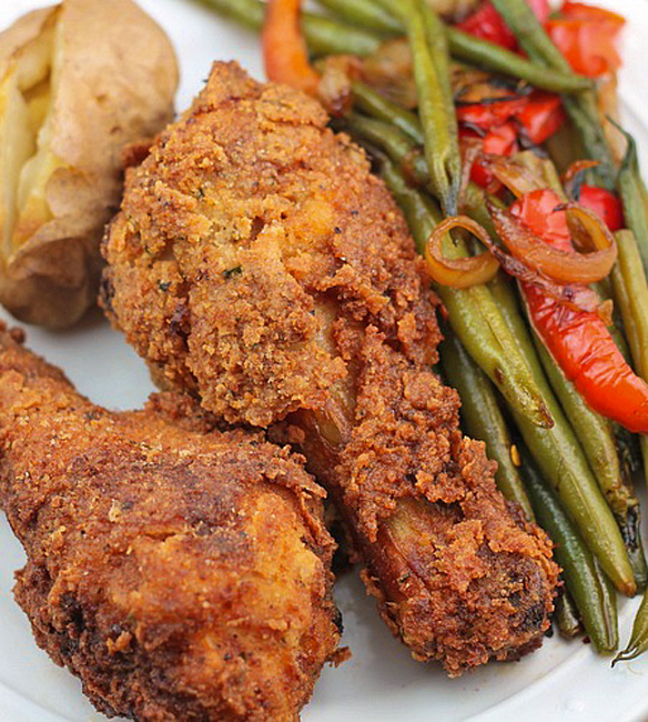 2 pieces of oven fried buttermilk chicken with a side baked potato and a side of green beans