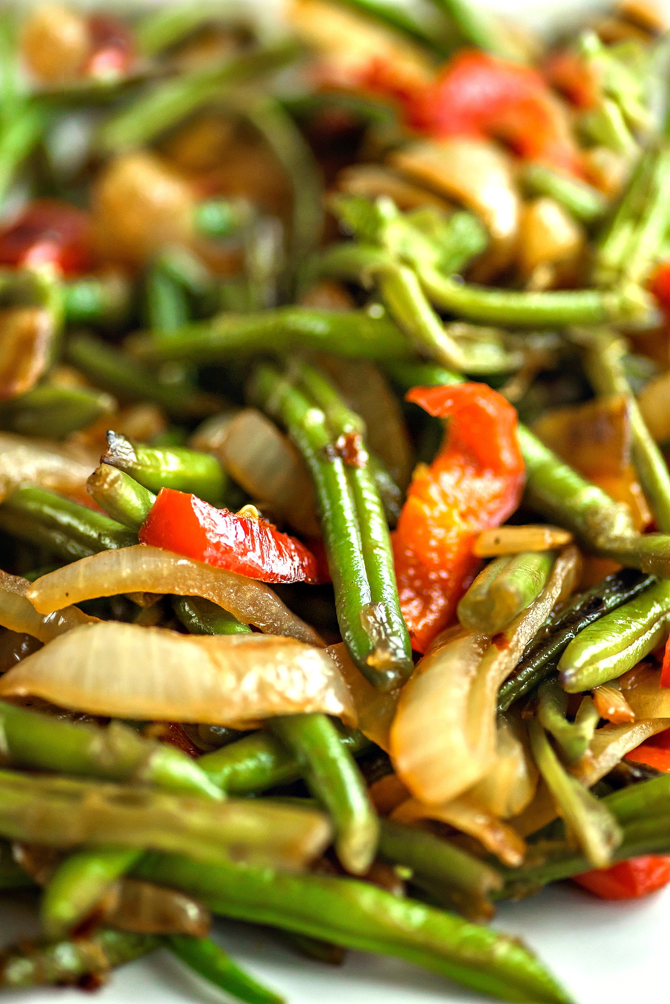 Green Beans Asian style has beautifully caramelized onions and peppers that are sweet to the taste.