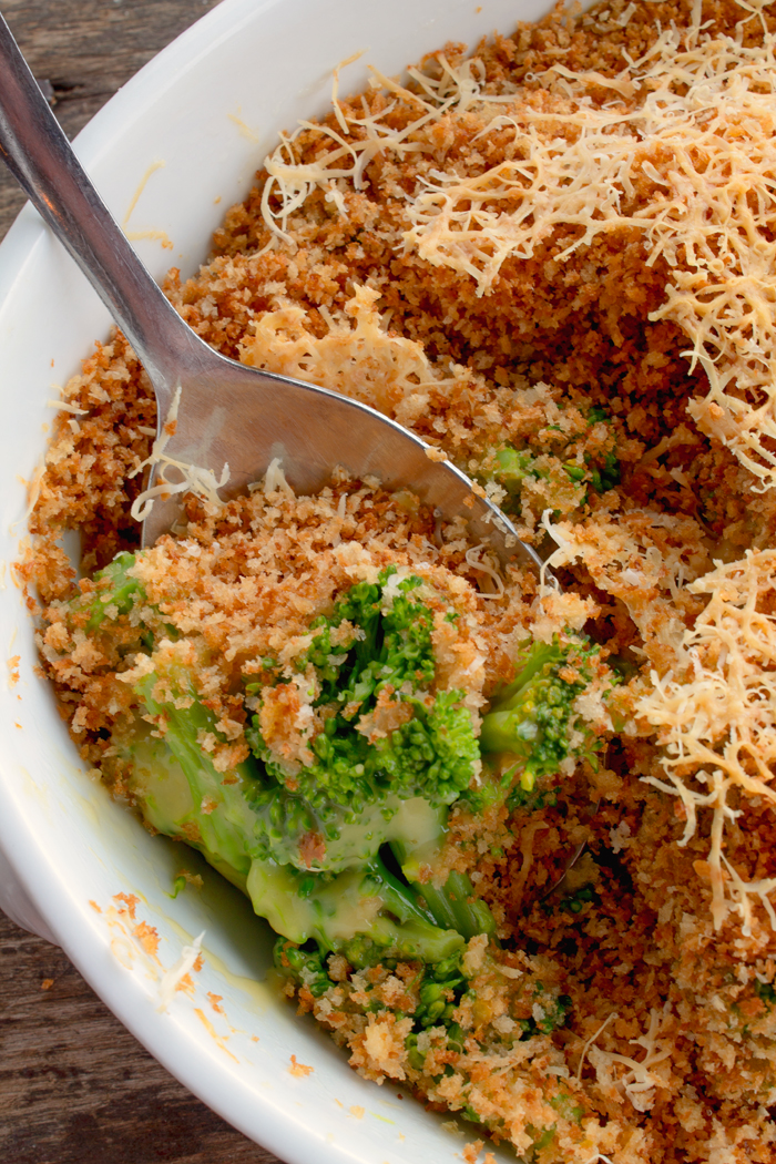 Cheesy broccoli topped with bread crumbs in a white casserole dish