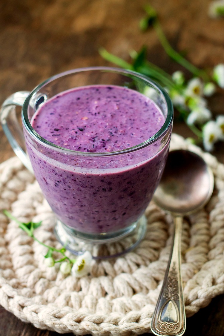 Blueberry smoothie in a glass cup on the table