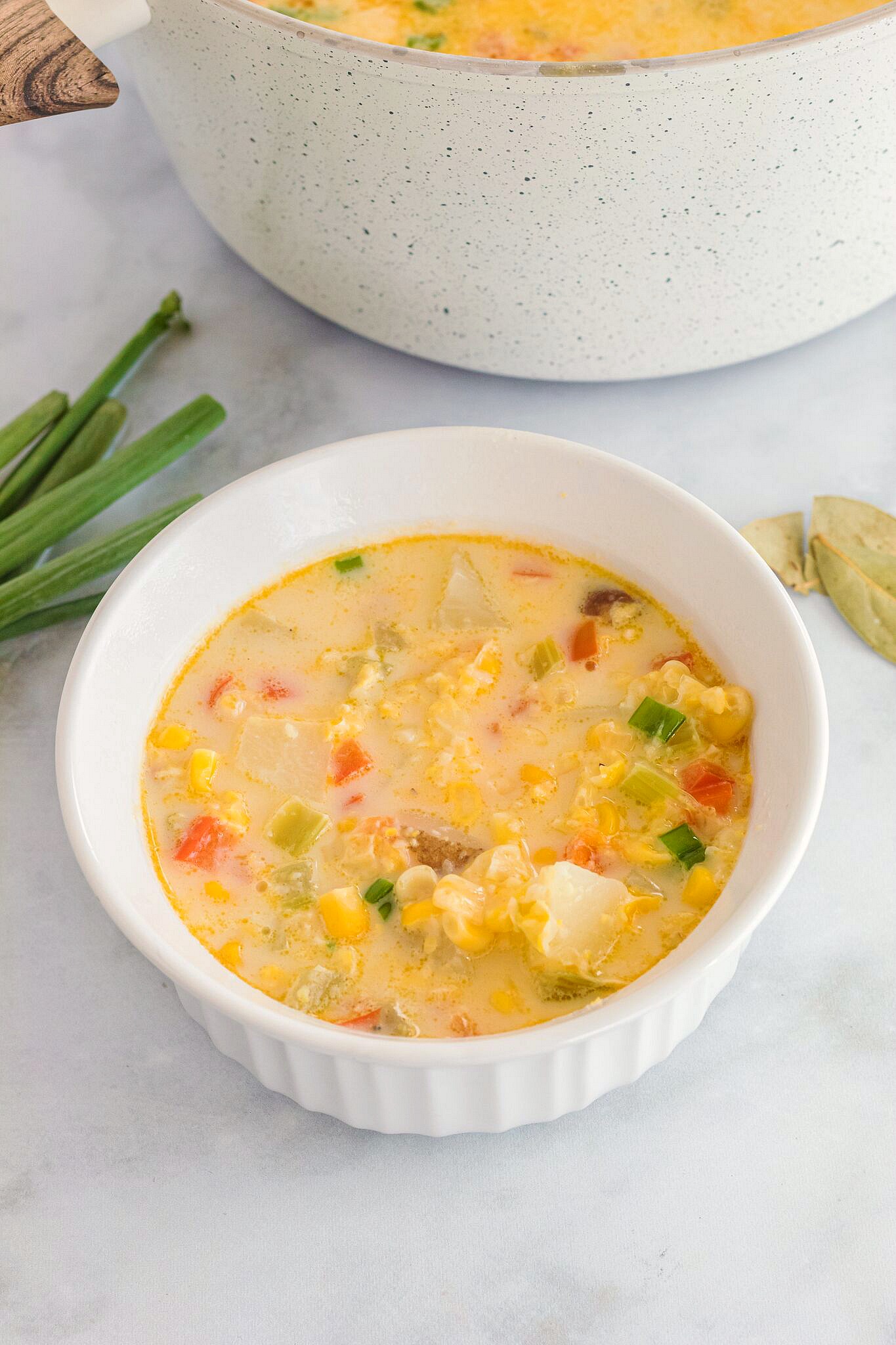 White bowl of creamy corn chowder 