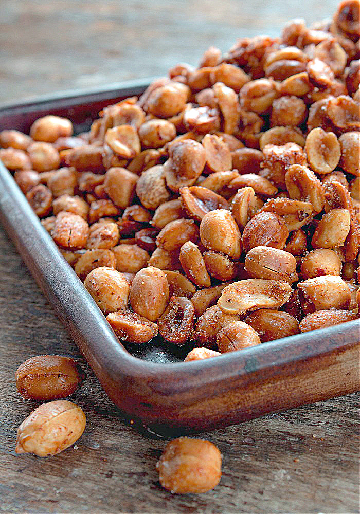 Spiced peanuts in a wooden dish on a table